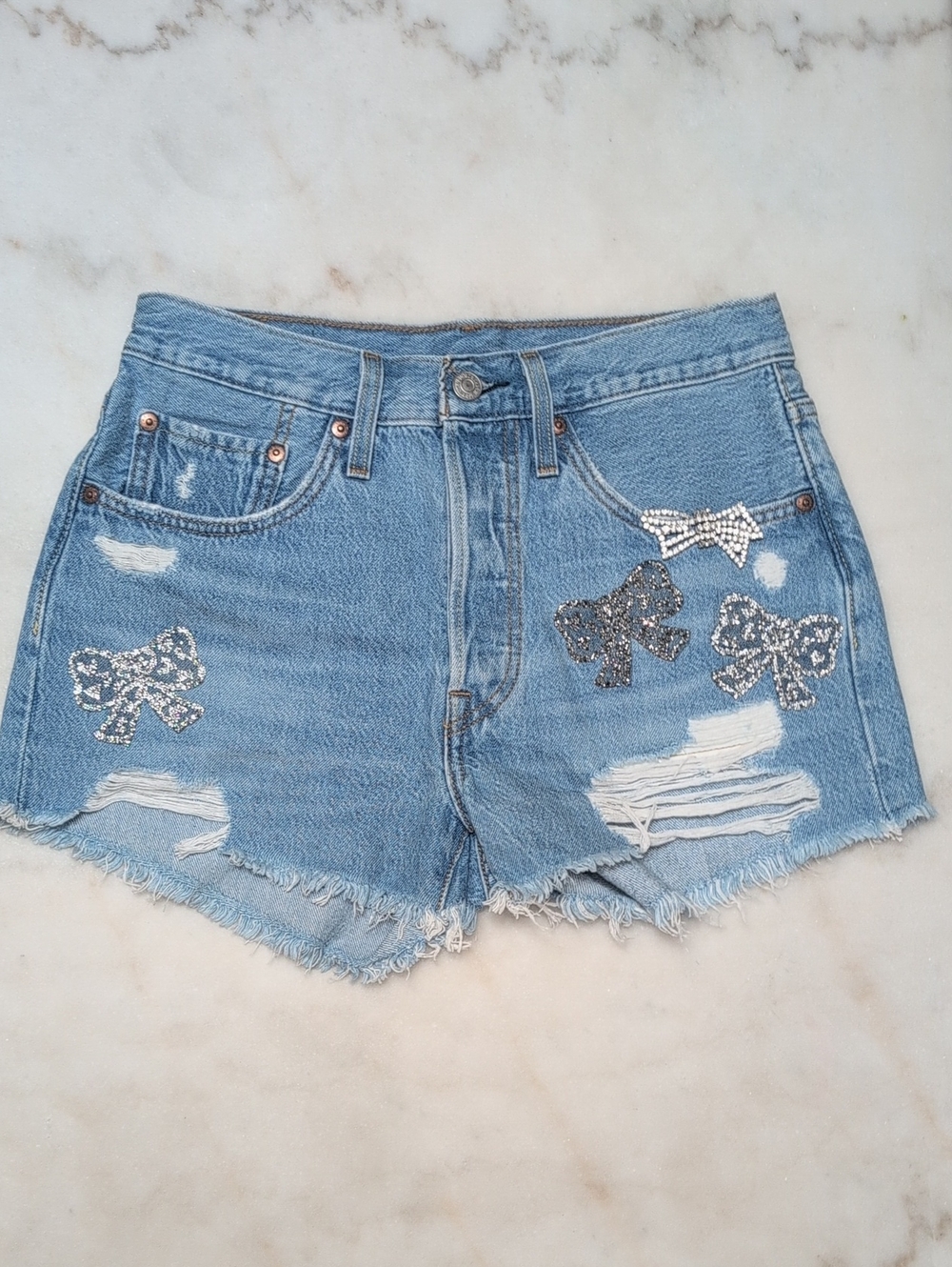 Levi's Light Blue Distressed Denim Shorts with Rhinestone Bow Accents